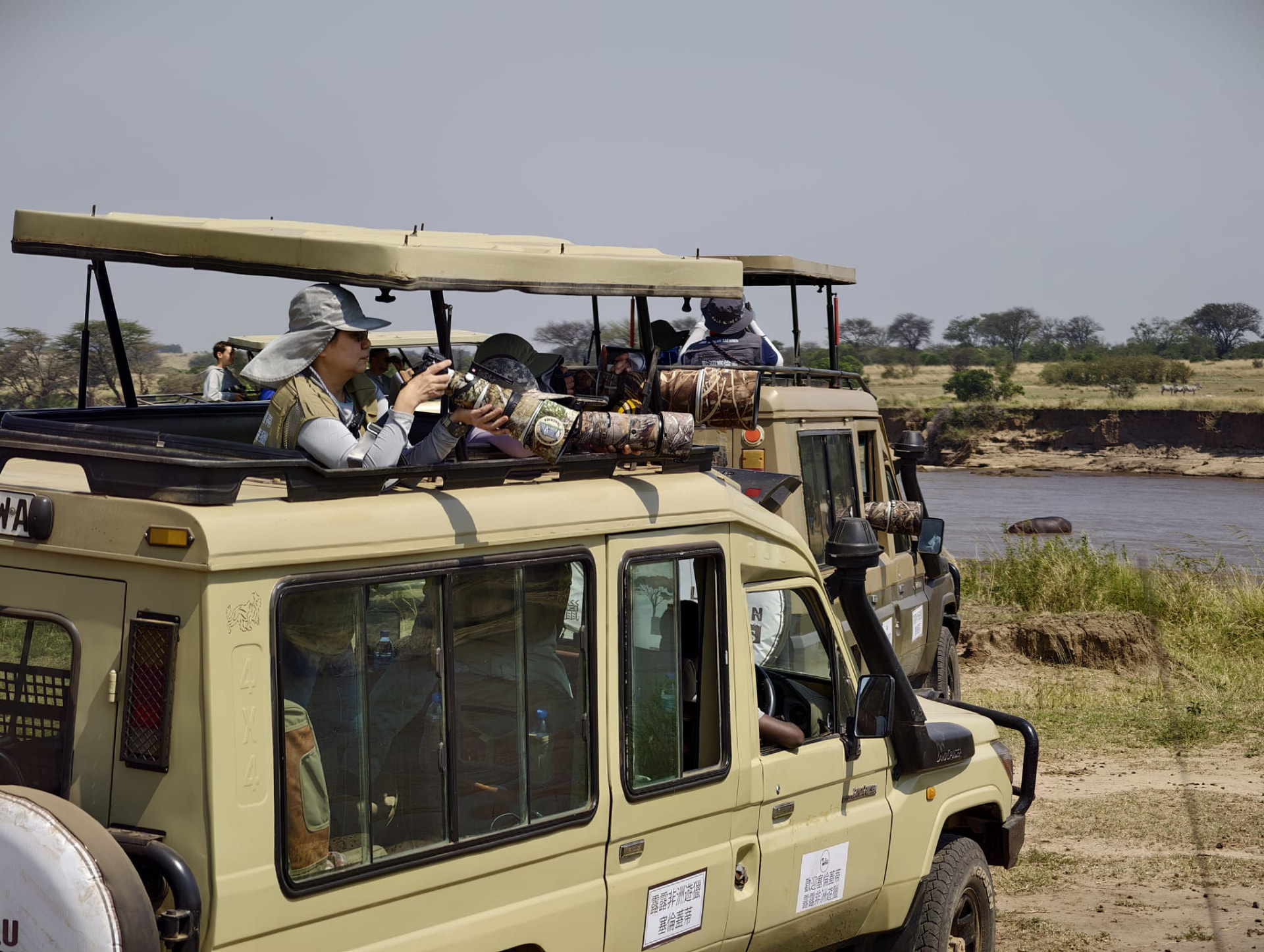 Guests photographing wildlife from Lulu African Safaris vehicles in the Serengeti